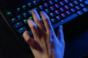 persons hand on black computer keyboard